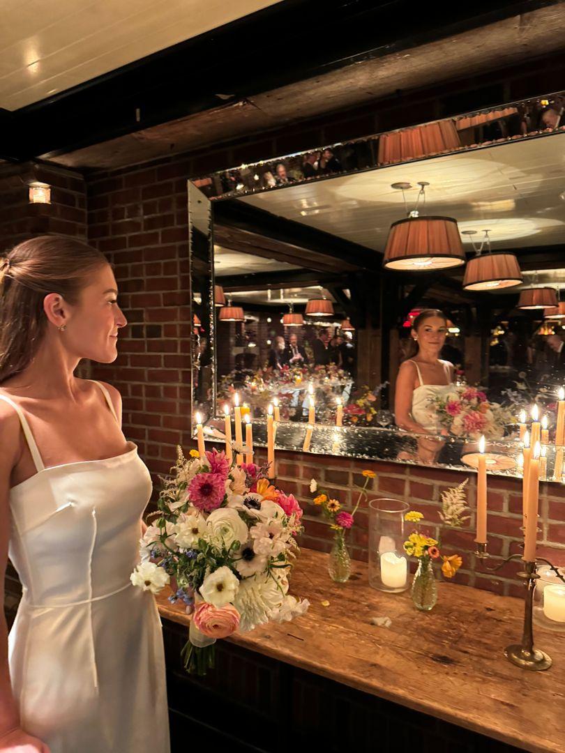 Bride looking into the mirror.