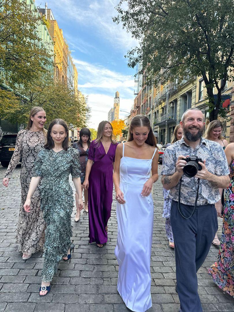 Bridal party walking in the street with the photographer.