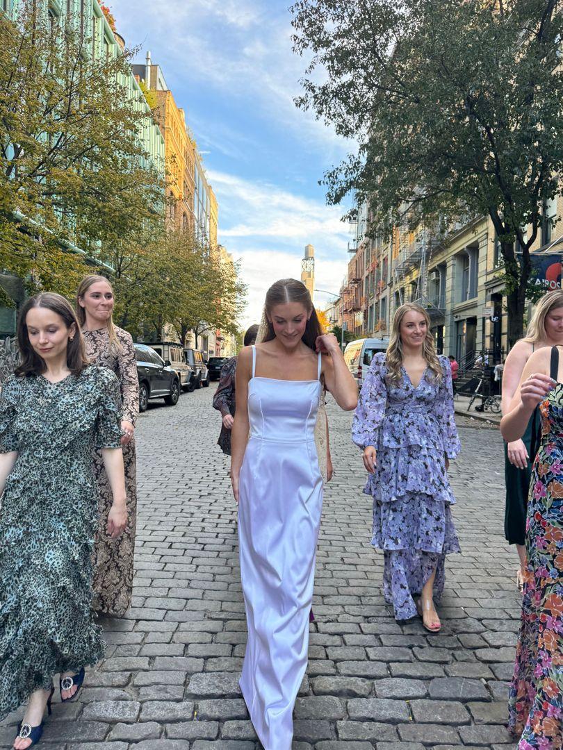 Bride and bridesmaids walking in the street.