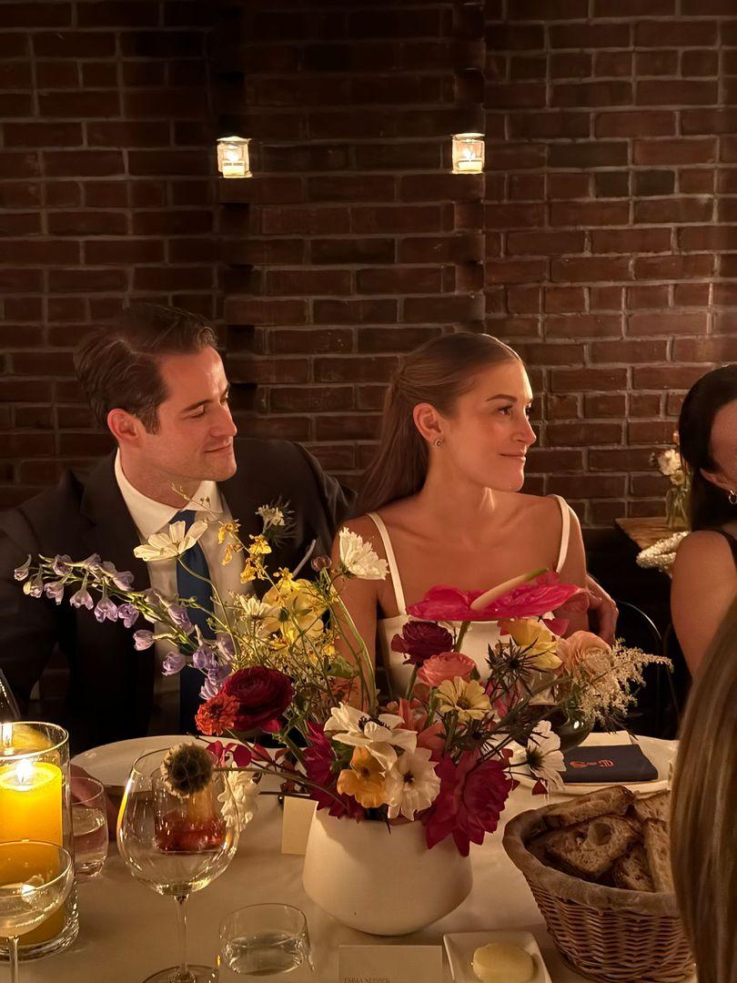 Bride and groom sitting at their table.