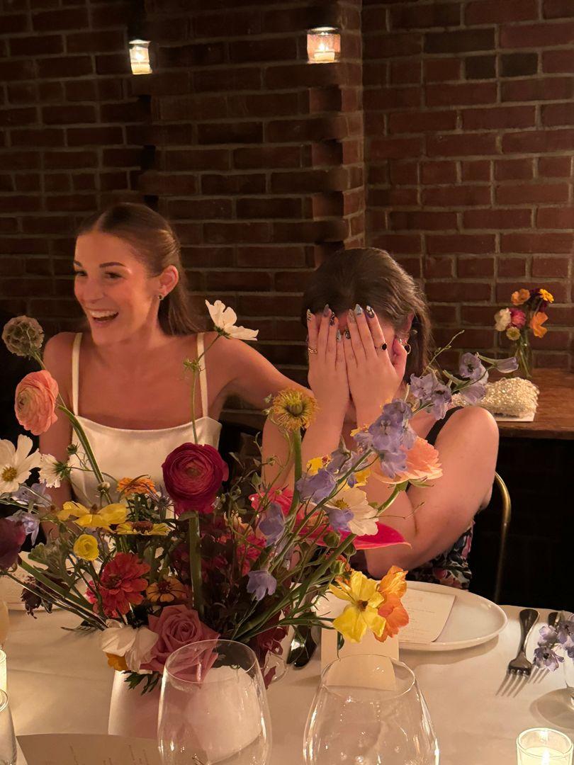 Bride comforting her friend who is getting emotional.