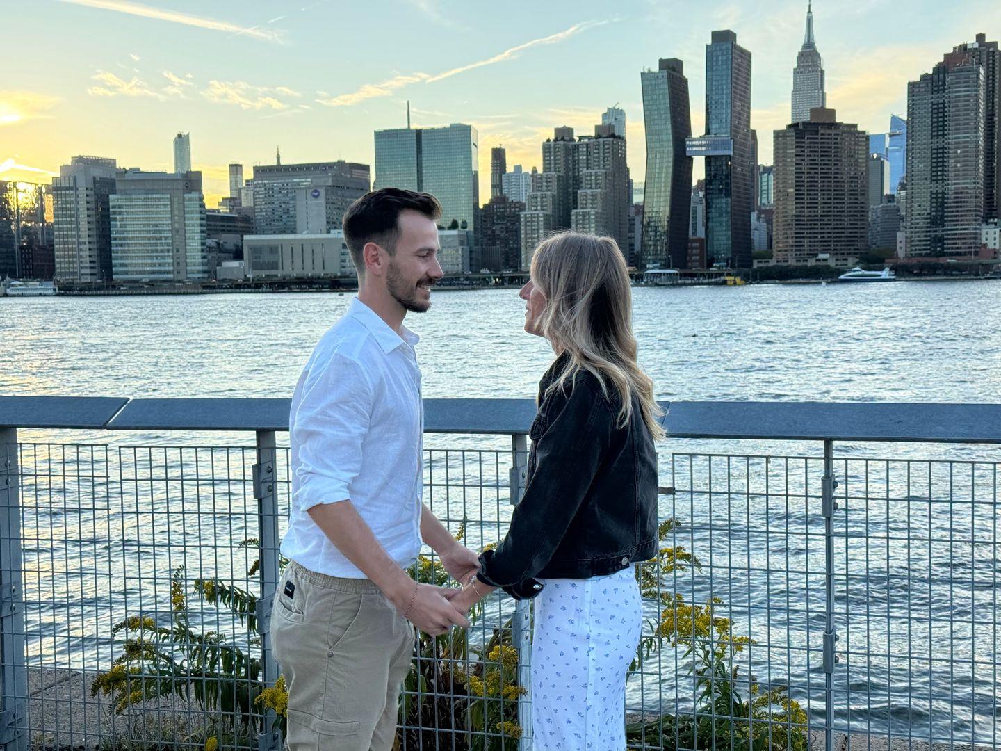 bride an groom holding hands at proposal