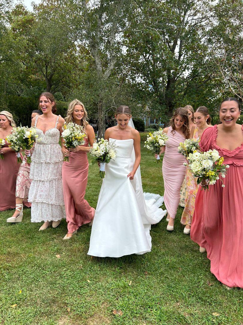 Bride and bridesmaids holding flowers.